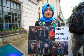 'Where are my Relatives' sign with peoples pictures on it. Uyghur citizen wants to know what happened to them.. Stop Uyghur people's Genocide done by China's government.